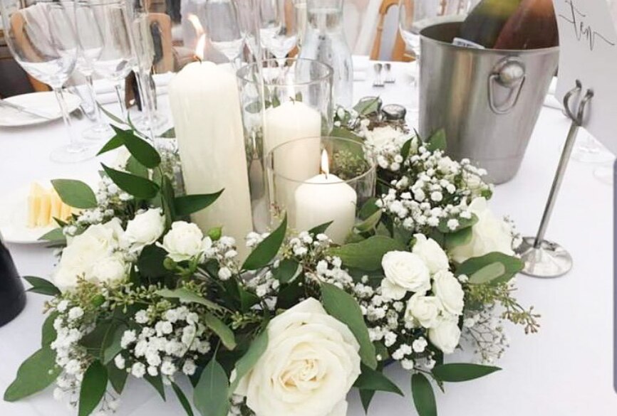A beautiful table arrangement of white flowers and candles